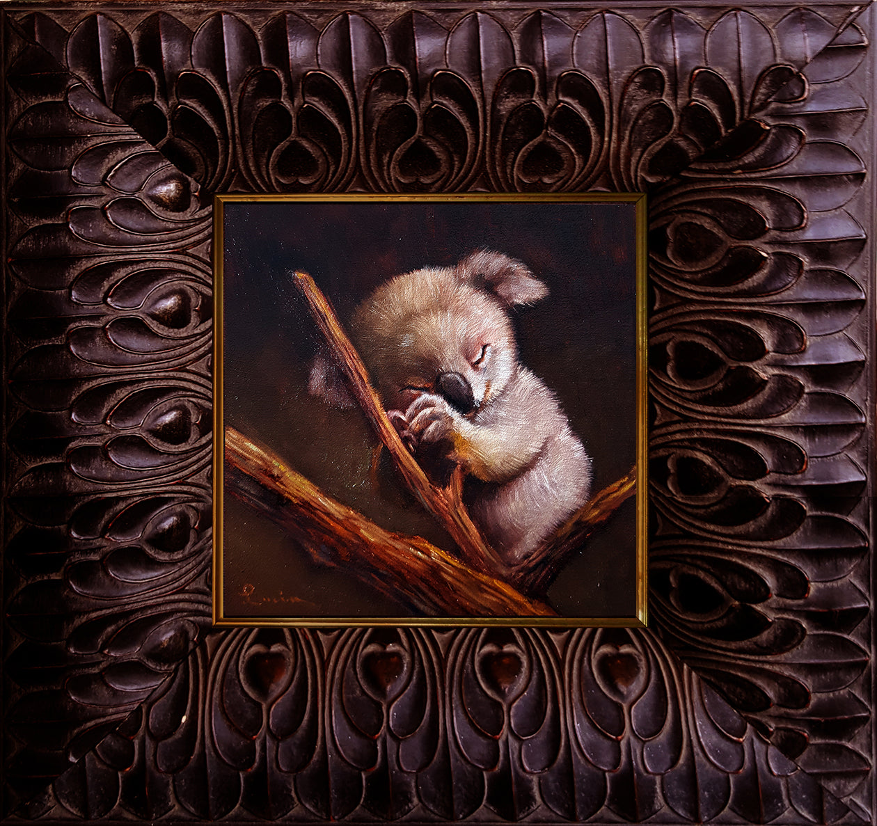 A framed oil painting on canvas of a koala bear resting on a branch, with a wooden frame.